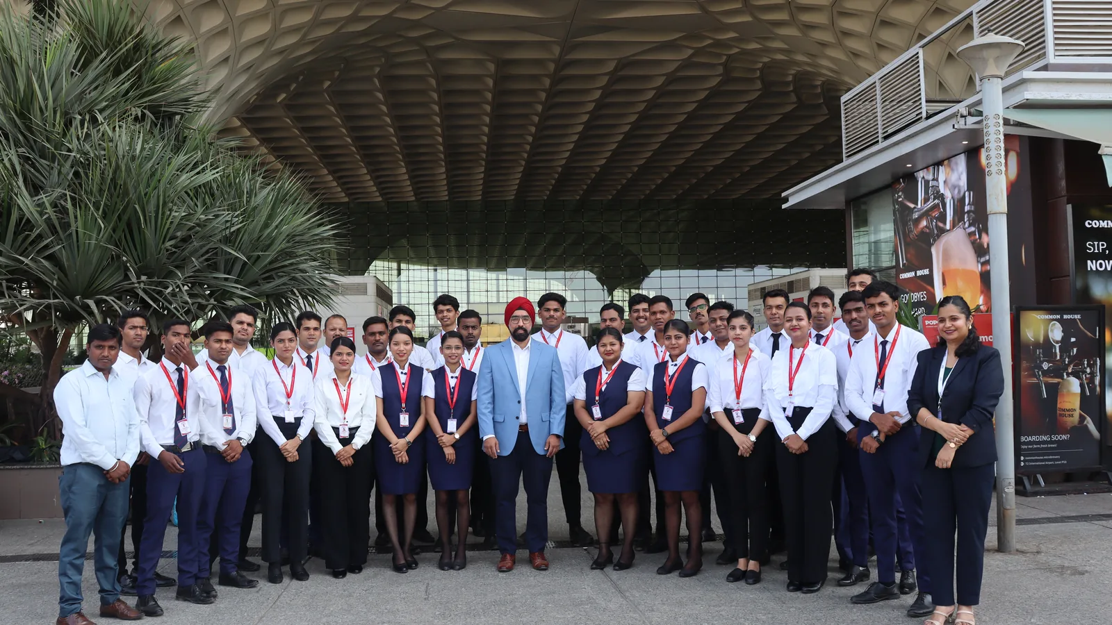 A full IESP batch in uniform outside Mumbai International Airport, with their trainers