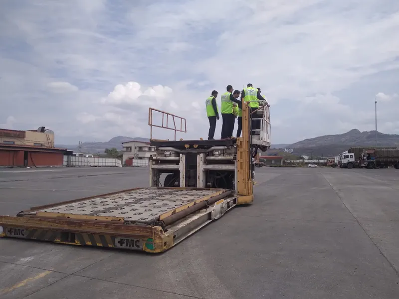 Students standing on a cargo loader platform on the apron