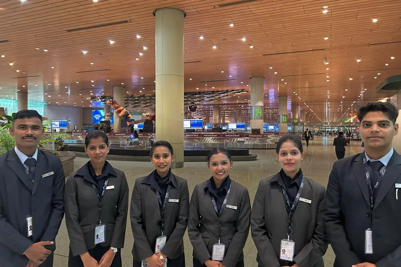 Airport staff in uniform inside a terminal hall