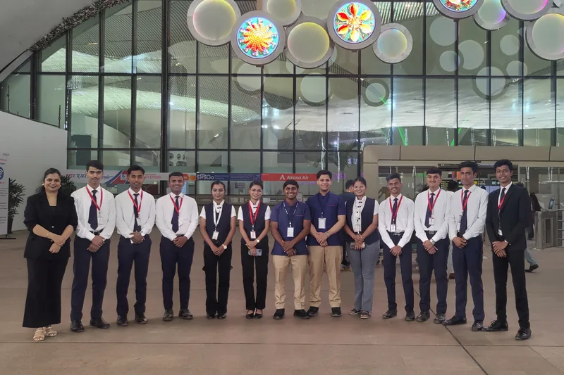 A group in uniform outside an airport terminal