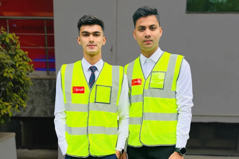 Two trainees in high visibility vests